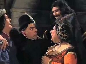 Prince Edmund cowers with a look of terror as the ugly Spanish Infanta tries to kiss him